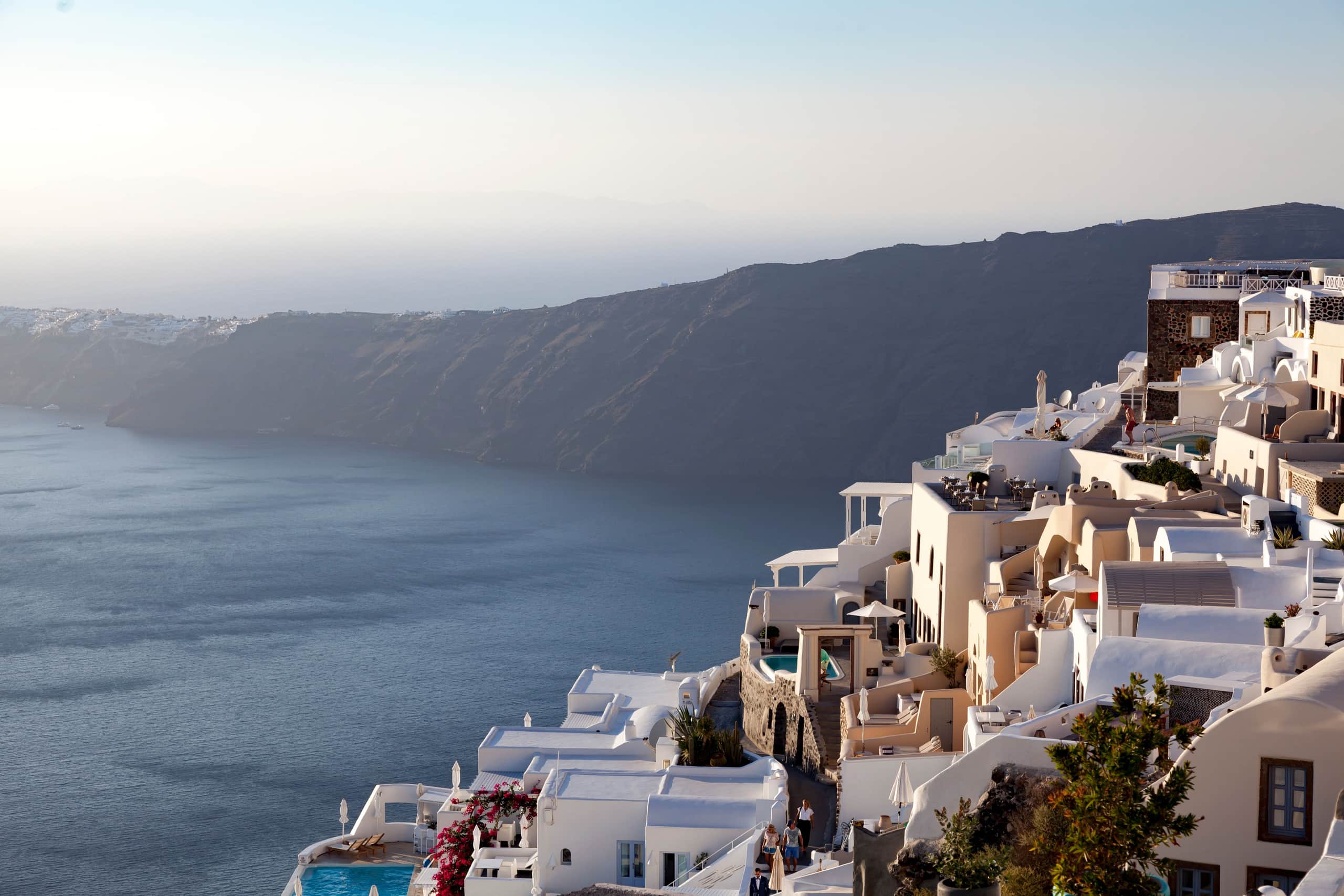 Whitewashed Imerovigli village glowing at sunset above the caldera